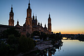 Cathedral-Basilica of Our Lady of the Pillar and the Ebro River bank at sunset, Zaragoza, Spain