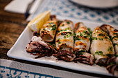 Grilled squid in La Arbica restaurant in Peñiscola, Castellon, Valencian Community, Spain