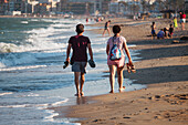 Couple walking on Peñiscola Beach, Castellon, Valencian Community, Spain