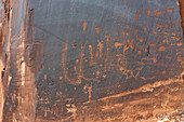 Historic Ute Indian & prehistoric Fremont Culture petroglyphs on a sandstone wall near Moab, Utah.