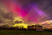 This captures the colourful rays of aurora towering up the sky and displaying a variety of colours from green to red and magenta, and at the right blue, the latter likely from sunlight interacting with the aurora. This was the great display of May 10/11, 2024 over my house in southern Alberta, Canada at latitude 51° N.