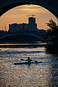 Kayakers at sunset on the Ebro River, Zaragoza, Spain