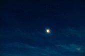 This is a wide-field view of the April 8, 2024 total eclipse of the Sun, taking in the bright planets Jupiter (at top) and Venus (below) that were easily visible to the unaided eye during totality. Here the Sun appears only as its outer atmosphere, the corona, in shades of yellow and blue, surrounding the dark disk of the Moon.