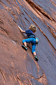 A young boy, age 6, learning to rock climb in Hunter Canyon near Moab, Utah.