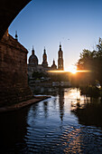 Cathedral-Basilica of Our Lady of the Pillar and the Ebro River bank at sunset, Zaragoza, Spain