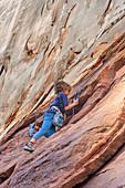 A young boy, age 6, learning to rock climb in Hunter Canyon near Moab, Utah.