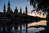 Cathedral-Basilica of Our Lady of the Pillar and the Ebro River bank at sunset, Zaragoza, Spain