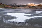 Ice Patterns on frozen Llyn y Dywarchen backed by Foel Goch and Foel Gronin in winter, Snowdonia National Park (Eryri), North Wales, United Kingdom, Europe