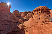 A narrow canyon running between several rock islands at Ferry Swale in the Glen Canyon Recreation Area near Page, Arizona, United States of America, North America