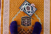 Muslim man praying on Islamic prayer mat with the Kaaba, Symbol of Islam, Chau Doc, Vietnam, Indochina, Southeast Asia, Asia