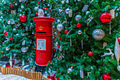 View of red postbox and Christmas decoration in hotel lobby, London, England, United Kingdom, Europe