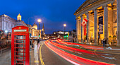 View of red telephone box and Trafalgar Square at dusk, Westminster, London, England, United Kingdom, Europe