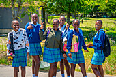 View of school girls smiling for camera in traditional Zulu village, Veyane Cultural Village, Khula, Khula Village, KwaZulu-Natal Province, South Africa, Africa