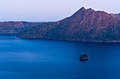 Calm purple evening light, of blue hour, deep blue Lake Mashu in a crater, Akan Mashu National Park, Hokkaido, Japan, Asia