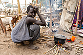 Young woman and cooking pot, Mundari tribe, South Sudan, Africa