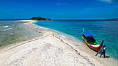 Aerial of little boat anchoring on Little Santa Cruz Island, Zamboanga, Mindanao, Philippines, Southeast Asia, Asia