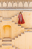 Woman in red garment at Panna Meena ka Kund, Jaipur, Rajasthan, India, Asia