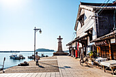 Iconic stone lighthouse at the port of the traditional fishing village, Tomonoura, Honshu, Japan, Asia