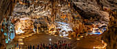 View of visitors viewing stalagmites and stalactites in the interior of Cango Caves, Oudtshoorn, Western Cape, South Africa, Africa