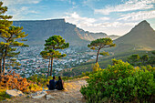 View of couple and Table Mountain from Signal Hill at sunset, Cape Town, Western Cape, South Africa, Africa