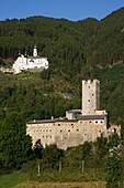 Italy, autonomous province of Bolzano, Val Venosta, Marienberg abbey perched on the side of a green mountain above the castle Furstenburg