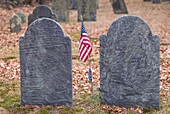 United States, New England, Massachusetts, Rowley, historic cemetery gravestones with US flag