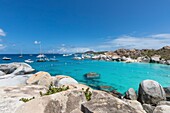 West Indies, British Virgin Islands, Virgin Gorda Island, The Baths, bathing beach view, sailboats at anchor, in the foreground the typical rocks that surround the paradisiacal swimming area