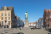 Belgium, Western Flanders, Bruges, historical centre listed as World Heritage by UNESCO, Jan Van Eyck square, statue of the Flemish painter and brick facades with stepped gables