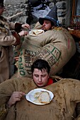 Switzerland, Valais Canton, Val d'Herens, village of Evolene, Carnaval, preparation of the empailles ( young men dressed with old bags stuffed with about 50 kgs of straw) and wearing a locally carved wooden mask representing mythical and often afraying animals