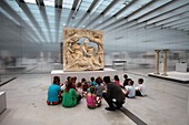 France, Pas de Calais, Lens, Louvre Lens Museum created by the Japanese architecture agency SANAA and architects Celia Imrey and Tim Culbert, a group of children in front of a statue