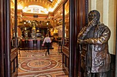 Ireland, Dublin, Green College, bar and restaurant The Bank, housed in the lobby of a former bank, Victorian architecture, at the entrance the statue of Con Houlihan, one of Ireland's most famous sports journalists