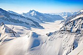 Switzerland, Canton of Bern, Bernese Oberland (highlands), Grindelwald, view to Jungfraufirn and Aletsch Glacier, part of Jungfrau Aletsch Bietschhorn UNESCO World Heritage Site and also called the Top of Europe (highest railway station in Europe), View to Sphinx Observatory (3571m) at mountain Sphinx near Jungfraujoch (3454m) (aerial view)