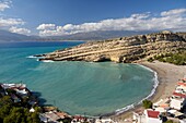 Greece, Crete, Matala, Matala Bay, beach and caves seen from the south cliff