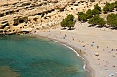 Greece, Crete, Matala, Matala Bay, beach and caves seen from the south cliff