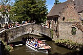 Belgium, West Flanders, Bruges, historical center listed as a UNESCO World Heritage, cruising tourist boat under the Bonifacius bridge