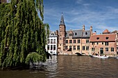 Belgium, West Flanders, Bruges, historical center listed as a UNESCO World Heritage, boat seen from the quay of the Rosary and passing next to the House of Tanners dating from the seventeenth century