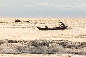 Cameroon, South Region, Ocean Department, Kribi, fishermen in canoes paddling in the waves