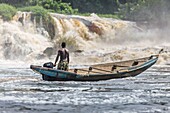 Cameroon, South Region, Ocean Department, Kribi, fisherman in a canoe in front of Lobe Waterfall