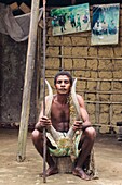 Cameroon, South Region, Ocean Department, Bagyeli village, Pygmy man proudly holding a hunting trophy, village near the Lobe River