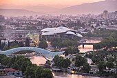 Georgia, Tbilisi, panorama over the city, Bridge of Peace over the Koura river and the Public Service Hall on the background