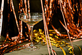 Champagne for new year greetings. Abstract golden background with champagne glasses and sparkler. Concept for celebrations with space for text.