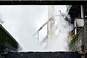 Huge, heavy steel production plant and industry terrain, producing various kinds of steel inside an CO2 Emitting and Exhausting Factory. IJmuiden, Netherlands.