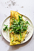 Frittata with asparagus and fresh ricotta served with arugula