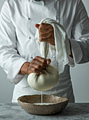 Action shot of a chef making labneh