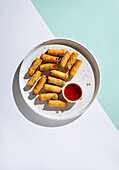 A Plate of Crispy Spring Rolls on a Pastel Backdrop