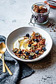 Yoghurt granola bowl with honey and blueberries