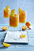 Ice cold orange slushy served in a tall stemmed glass