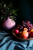 Seasonal Autumn Fruit Bowl with Apples, Mangoes and Grapes.