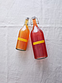 Top view of two bottles with different flavours of the homemade fermented drink kombucha