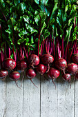 A collection of fresh beetroot on a gray woody backround